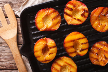 Ripe peaches on a a grill pan close-up. horizontal top view
