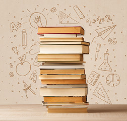 A pile of books on table with school hand drawn doodle sketches