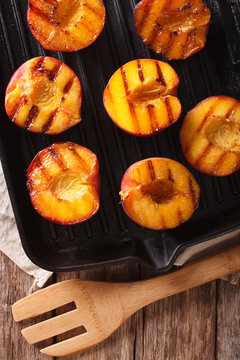 Ripe peaches on a a grill pan close-up. Vertical top view
