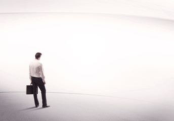 Businessman with briefcase standing still