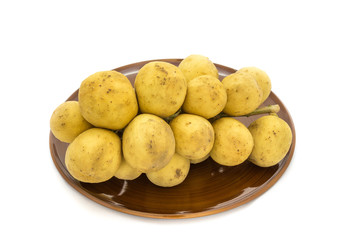 Wollongong delicious fruit or Longkong fruit or Lansium parasiticum in plate is tropical fruit in south east Asia on white background