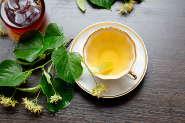 porcelain Cup of Linden tea on a background of dark wood