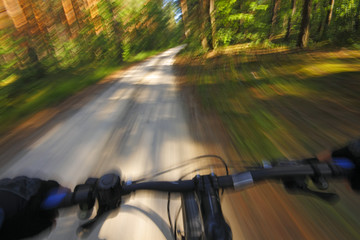 Fototapeta na wymiar Fast motion mountain bike on a road