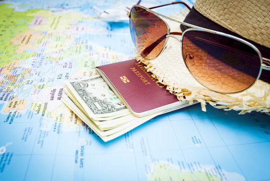 Hat, Sunglasses, Passport, Money And Aircraft On The World Map