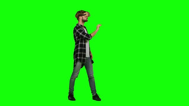 Man in virtual reality glasses. Green screen