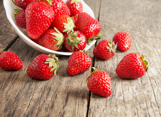 Ripe red strawberries on wooden table