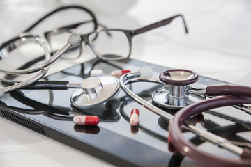 medical stethoscope and pill tablet still life on the theme of diet