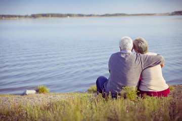 adult couple seniors on the shore of lake