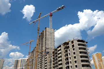 Fototapeta na wymiar New high-rise modern apartment buildings construction in process ob bright sunny day side view horizontal