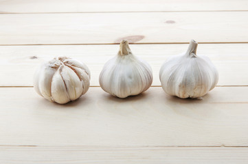 Organic garlic whole and cloves on the wooden background