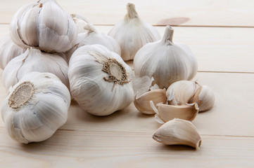Organic garlic whole and cloves on the wooden background