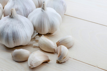 Organic garlic whole and cloves on the wooden background