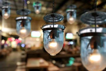 Fototapeta na wymiar Warm lighting modern ceiling lamps in the cafe.