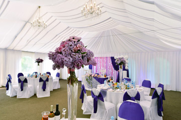 Beautiful wedding restaurant for marriage. White decor for bride and groom. Colorful decoration for celebration. Beauty bridal interior. Bouquet, food and flowers in hall