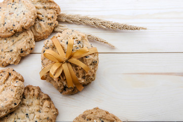 Place the cookies with a ribbon tied on a wooden floor.