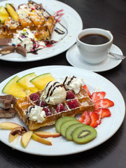 Belgian waffles with ice cream, chocolate and strawberries