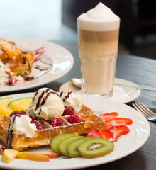 Belgian waffles with ice cream, chocolate and strawberries