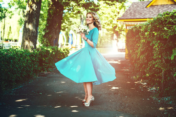 Young and happy beautiful bride outdoor in the park