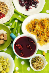 Cup of tea with aromatic dry tea on wooden background