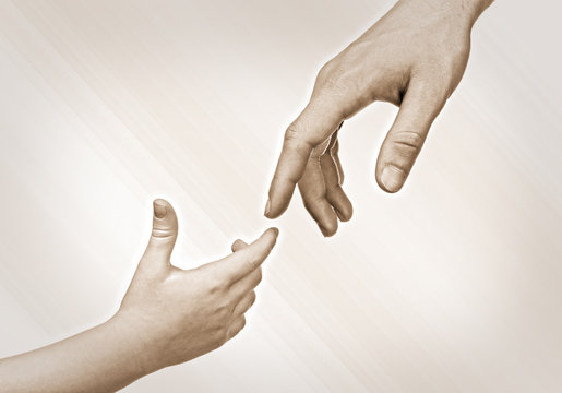 Child and father hands together on light background