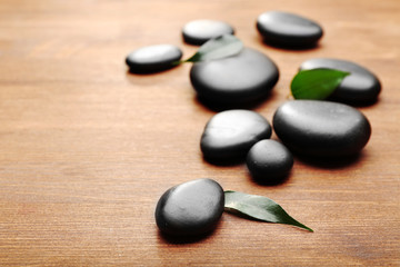 Heap of spa hot stones  on wooden background