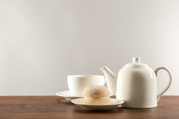 Obraz na płótnie Canvas White ceramic tea set on wooden table