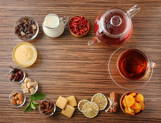 Tea composition on wooden background, flat lay