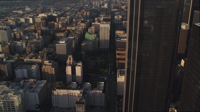 Flying past midsections of Los Angeles skyscrapers to view of Westin Bonaventura Hotel in shadow. Shot in 2010.