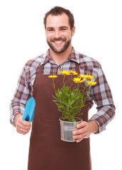 Gardener holding flowers and garden trowel