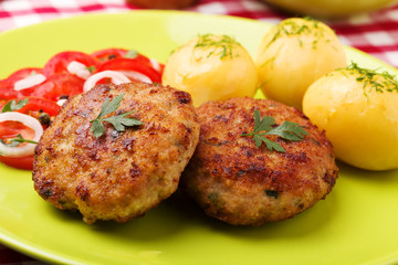 Fresh, homemade meatballs, served with tomato salad and new pota