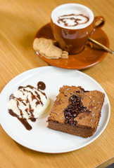 brownie and whip cream on a wood table. selective focus