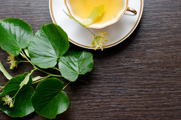 porcelain Cup of Linden tea on a background of dark wood