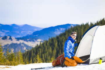A climber collects things before climbing into the mountains.