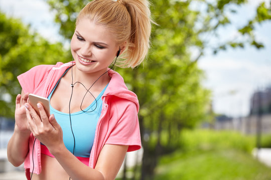 fitness and lifestyle concept - woman doing sports and listening