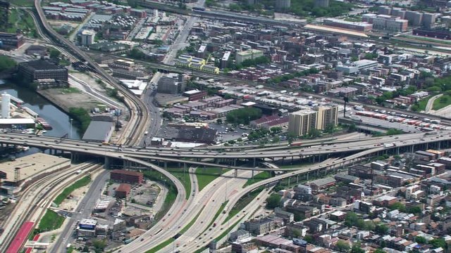 Zoom-out from overhead view of freeway interchange to Chicago skyline. Shot in 2003.