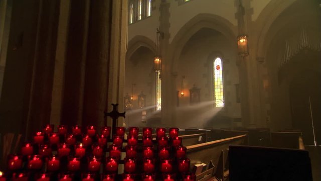Light streaming through empty nave of Catholic church