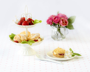 cream puffs or profiterole filled with whipped cream served with strawberries in plateau