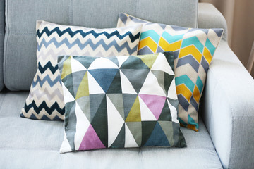 Stylish pillows on grey couch