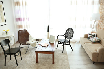 Modern living room interior. Different kinds of chair around table.