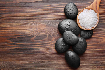 Obraz na płótnie Canvas Spa stones with salt on wooden background