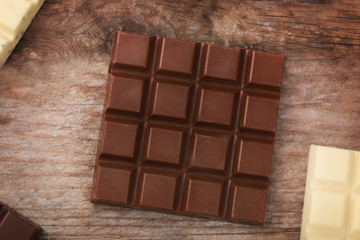 Chocolate bars on wooden background