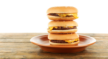 Tasty cheeseburgers on plate, isolated on white