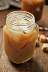 Iced coffee with milk on wooden table