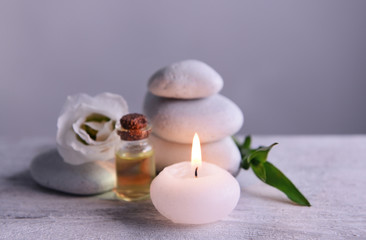 Spa composition with candle on gray background