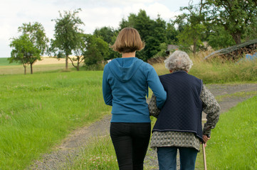 Junge Frau und Seniorin gehen spazieren