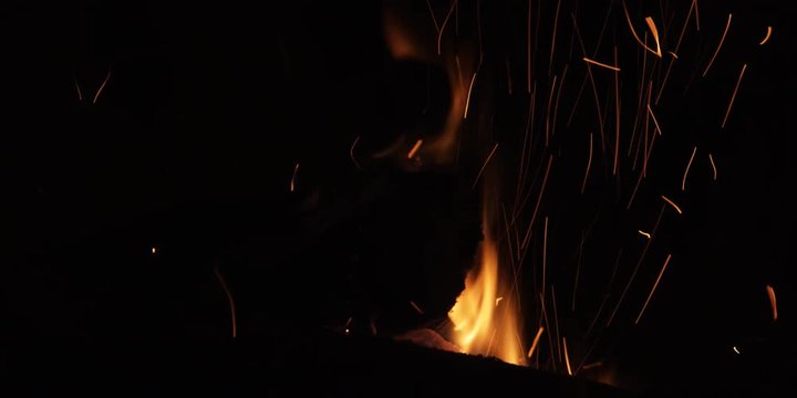 Wood on a fire burning through and dropping into the flames