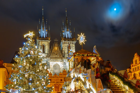 Old Town Square with Christmas tree and fairy tale Church of our Lady Tyn in the magical city of Prague at moonlight night, Czech Republic
