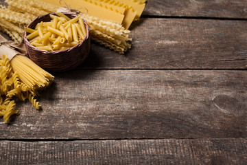 Mixed pasta . On a wooden background. Top view