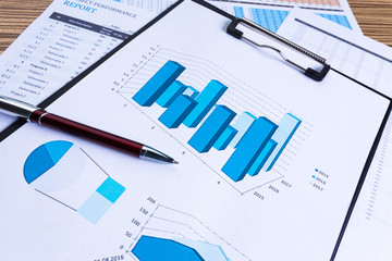 Business performance graph with ballpoint pen