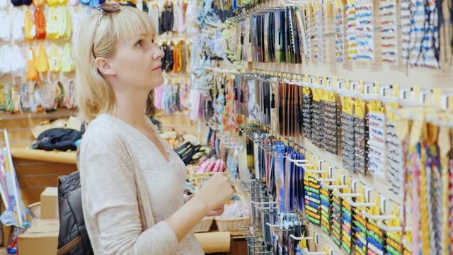 Female tourist chooses souvenirs in store for tourists